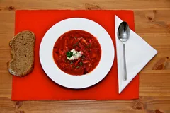 My borscht doesn’t look nearly this nice, but it tastes good. (Photo: https://commons.wikimedia.org/wiki/File:Borscht_with_bread.jpg)